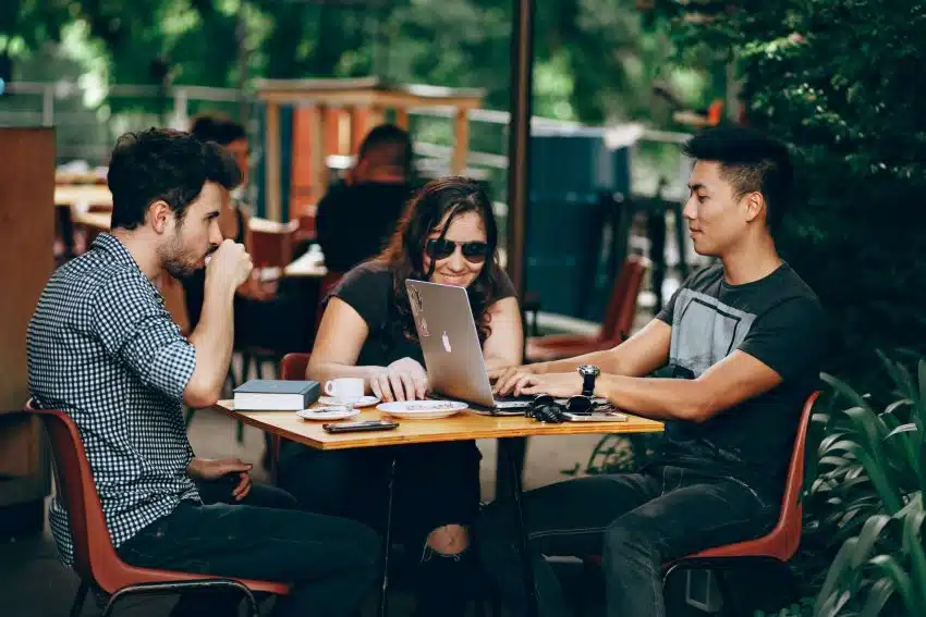 Group of three college students at a cafe