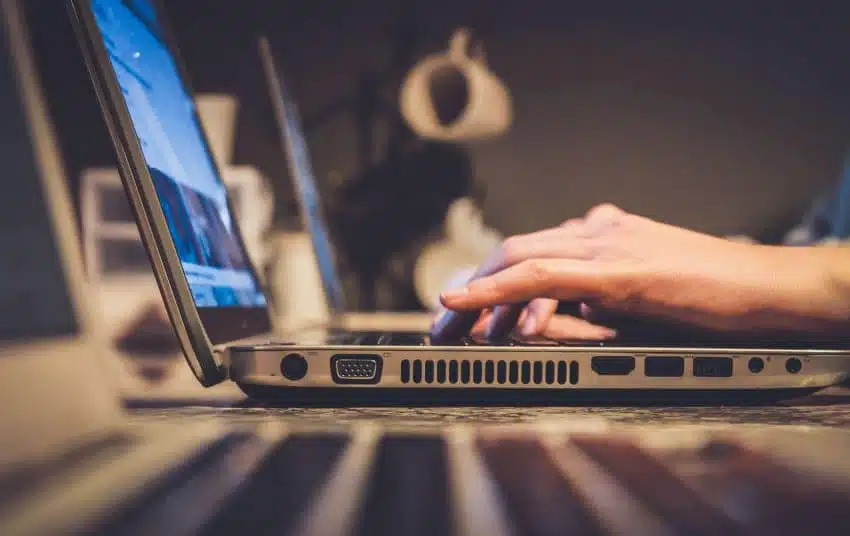 Student typing on laptop