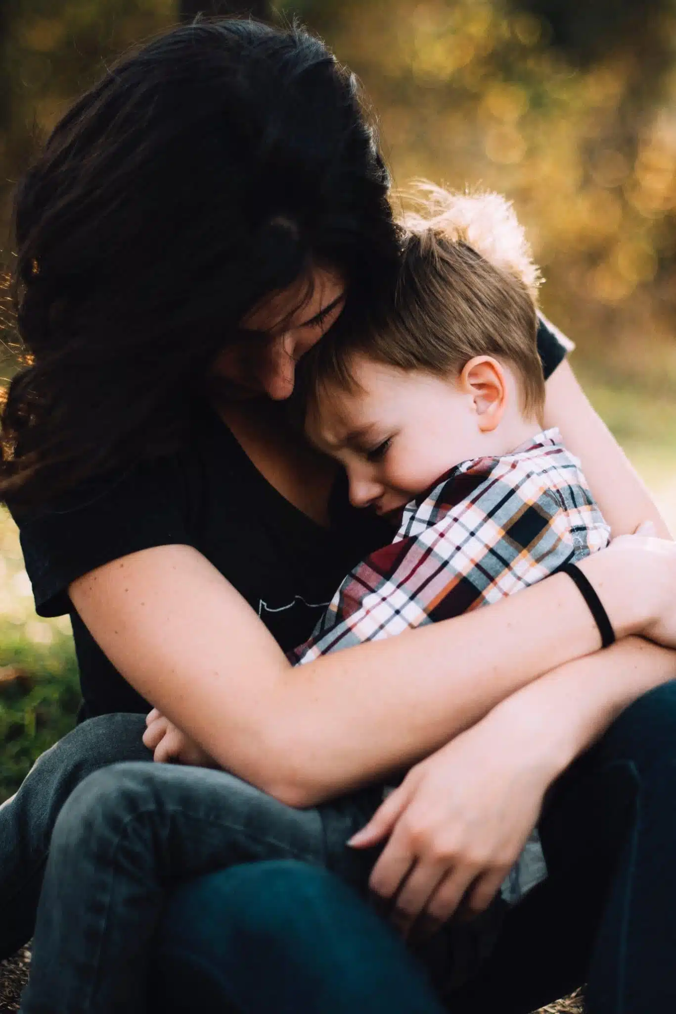 A mom comforts her upset child, as parents just want to protect their kids.