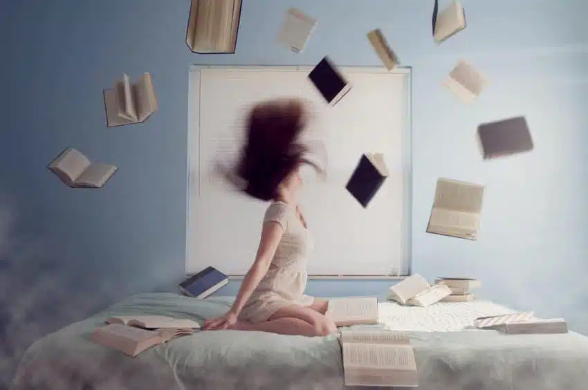 Overwhelmed college students throwing books in the air