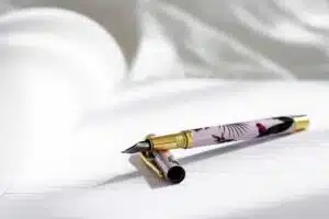 Ink pen on paper before writing an essay