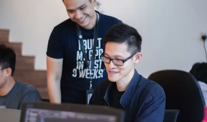 Student and mentor work together on computer