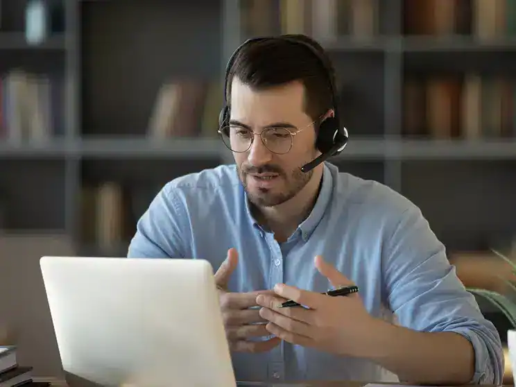 male transfer student speaking with a college counselor online