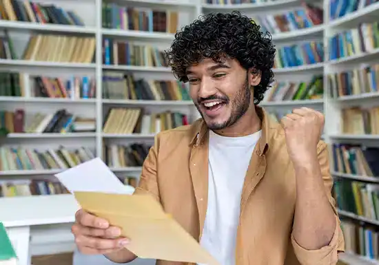 a male college student excited at having received a scholarship