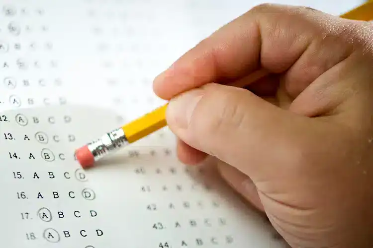 an OMR sheet being filled with a pencil