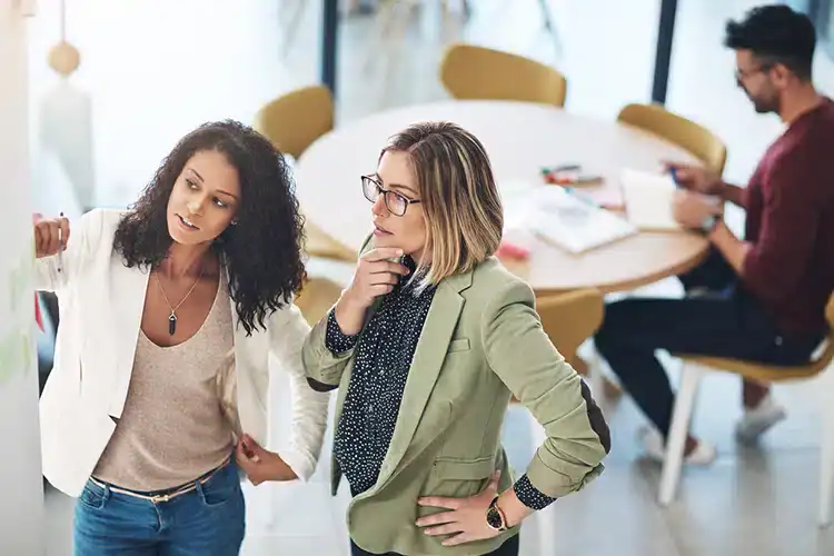two female design thinkers brainstorming a project together