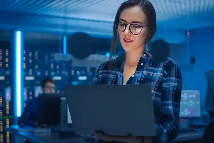 a female cybersecurity professional working on her laptop