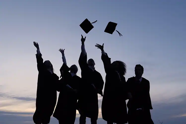a bunch of university graduates celebrating having earned their degrees